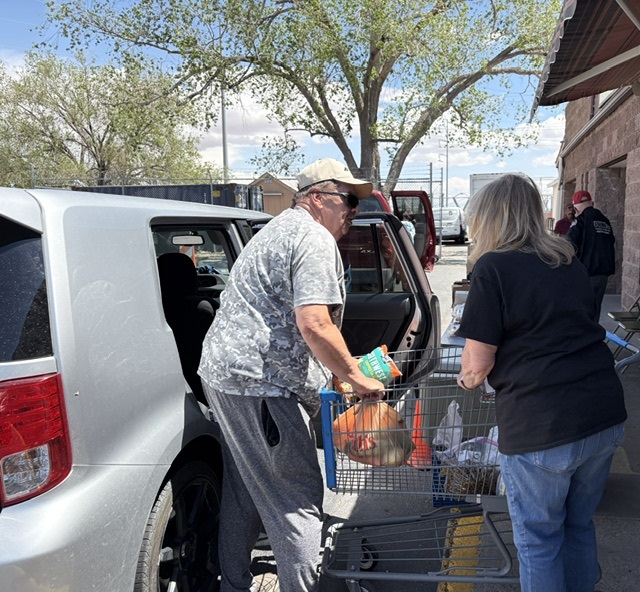Volunteer loading food donations